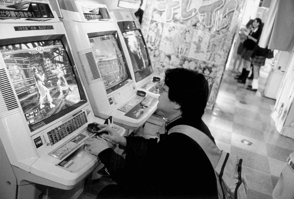 Zwart-wit foto van jongeren die videogames spelen in een lunapark