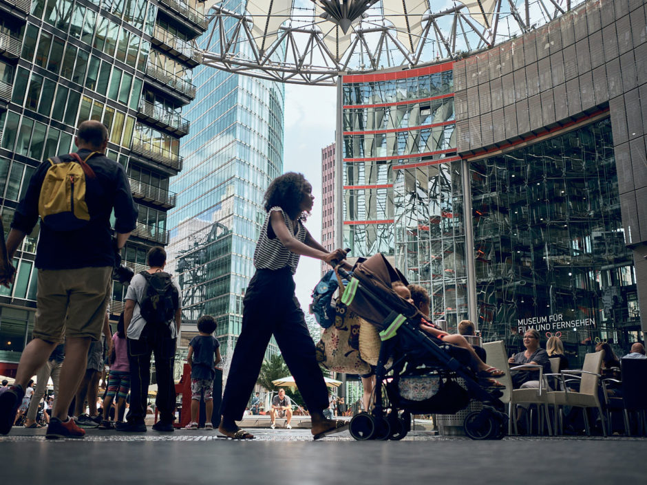 Kleurfoto van een jonge moeder met buggy aan het Sony Centre