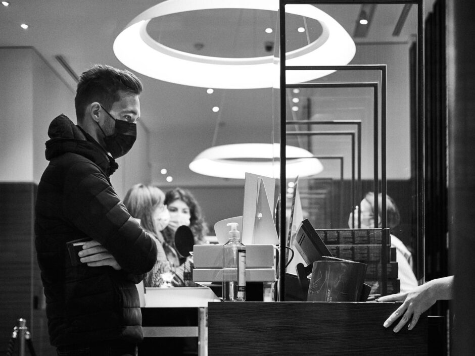 Black & white image of a young man in a Nespresso shop